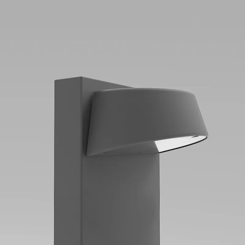 Mörk pollararmatur med integrerat LED-ljus i armaturhuvudet.
