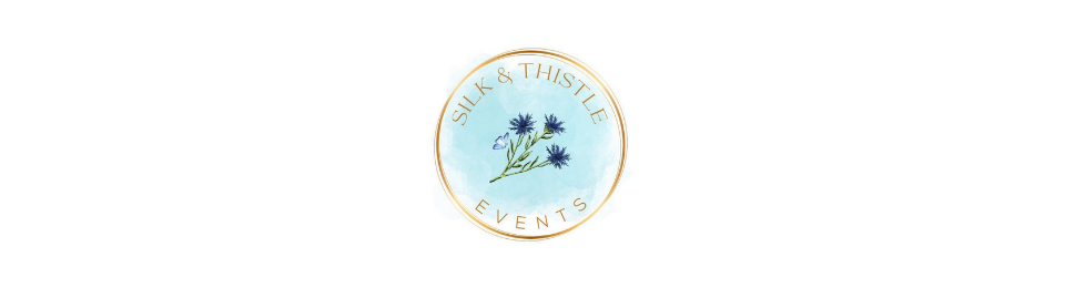 Small round blue logo with a delicate floral branch and gold border on a white background