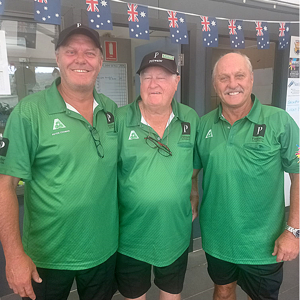 Group of smiling club members wearing green Pittwater RSL shirts standing outdoors