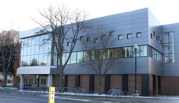 A large building with a lot of windows and a tree in front of it