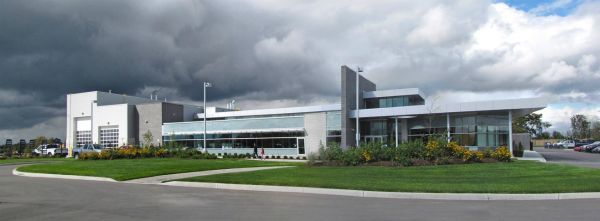 A large building with a cloudy sky in the background
