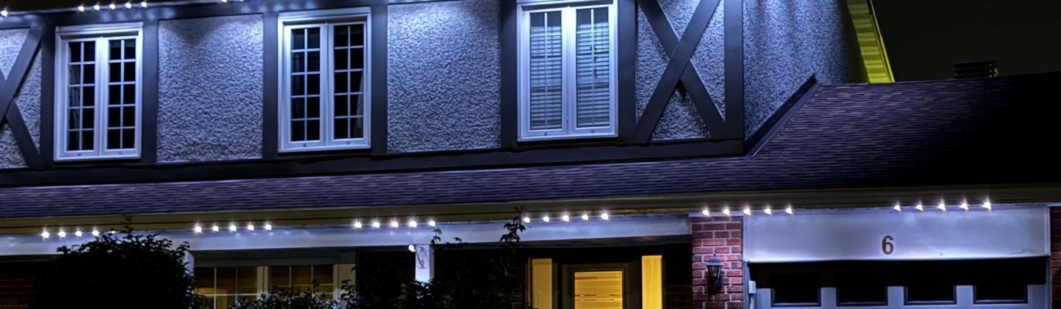 Cool white permanent accent lighting on a Tampa home roofline and garage
