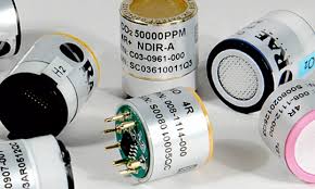 Assorted cylindrical gas sensors and detector capsules on a white background, with labels and colored end caps