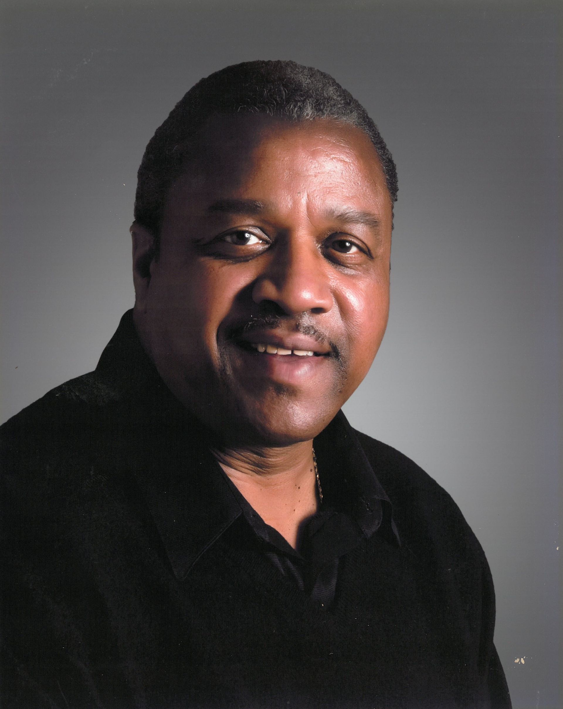 a man in a suit and tie smiles for the camera
