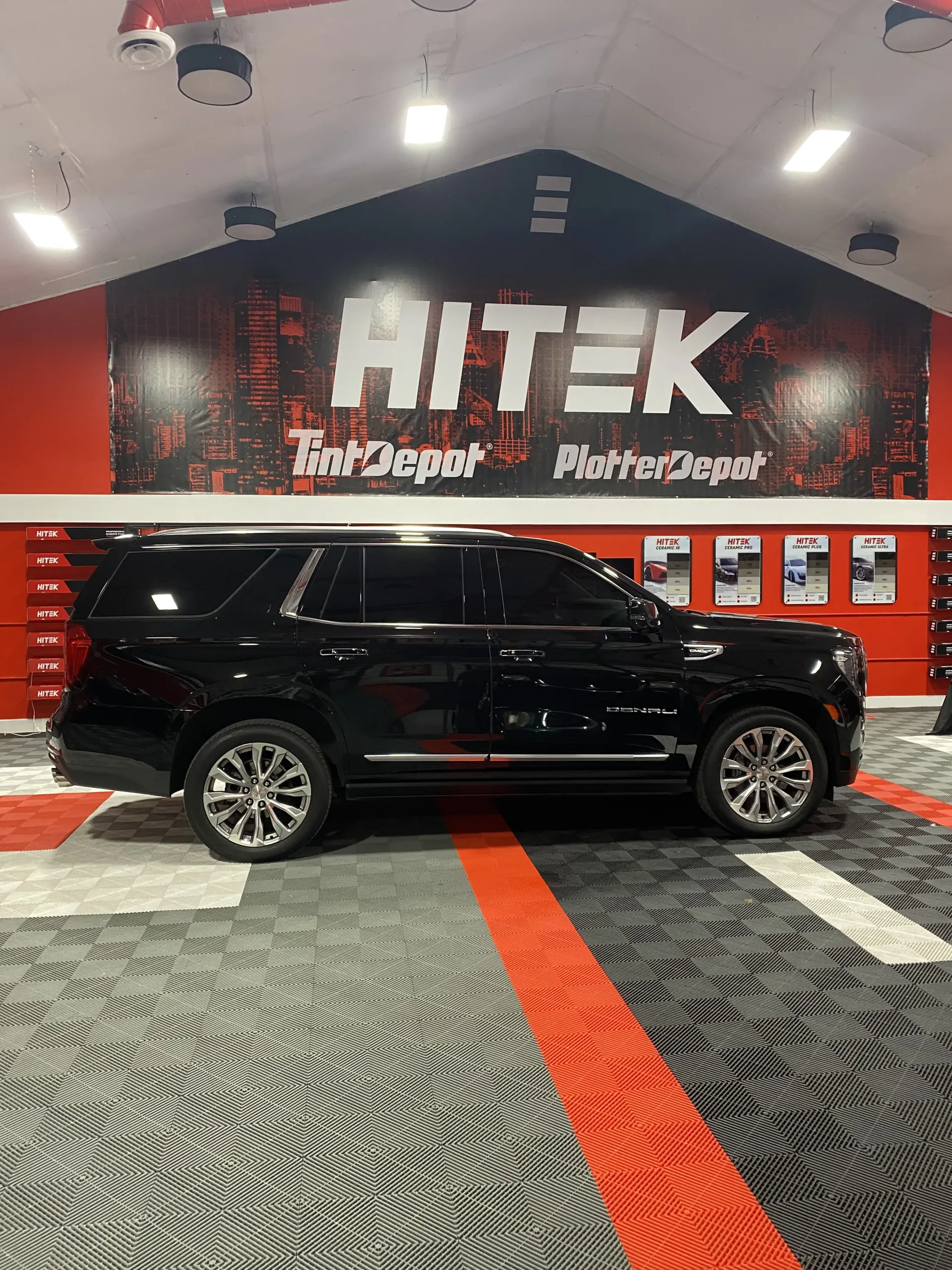 Black SUV in a shop with 