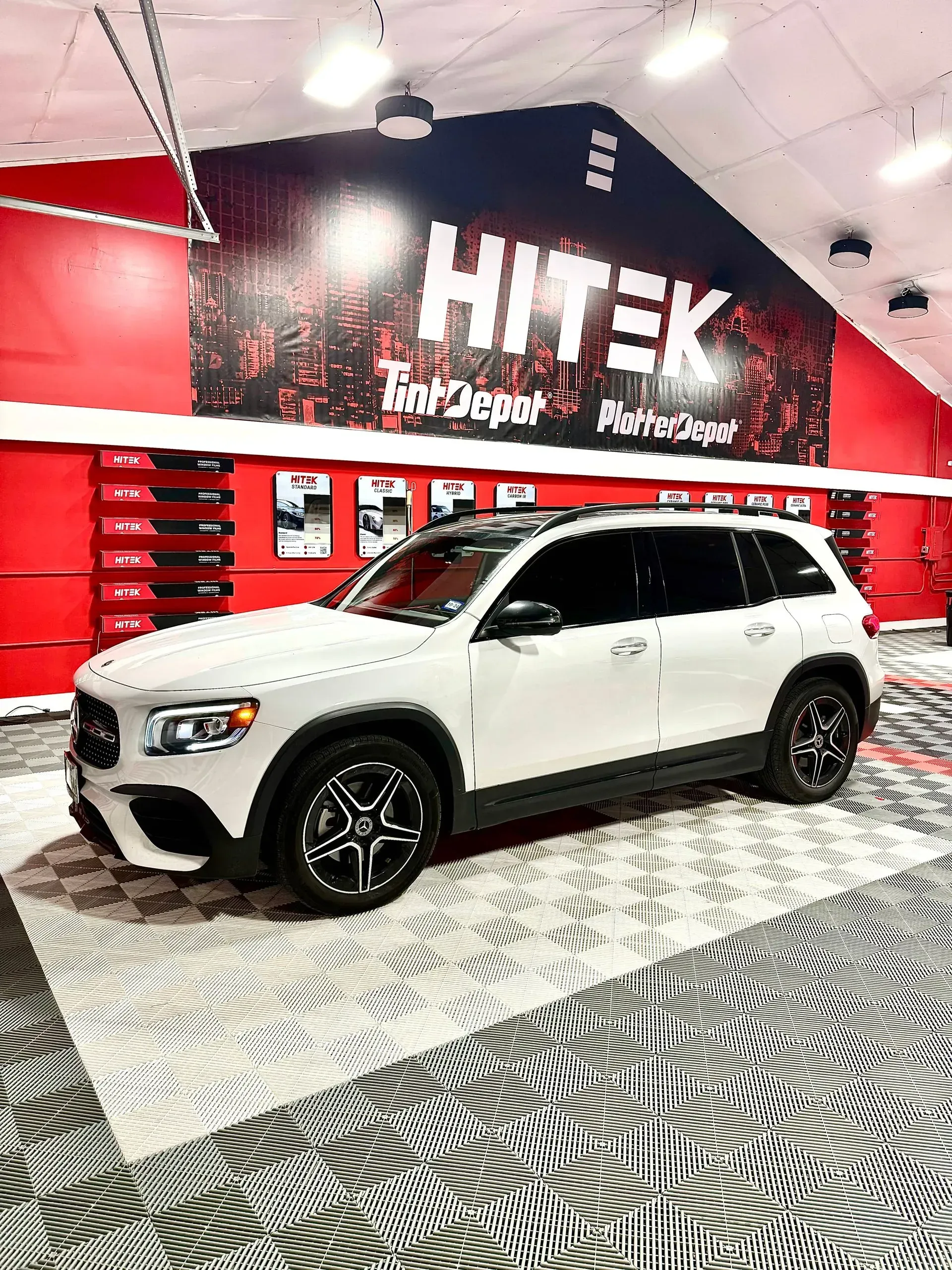 White Mercedes SUV parked in a garage with 