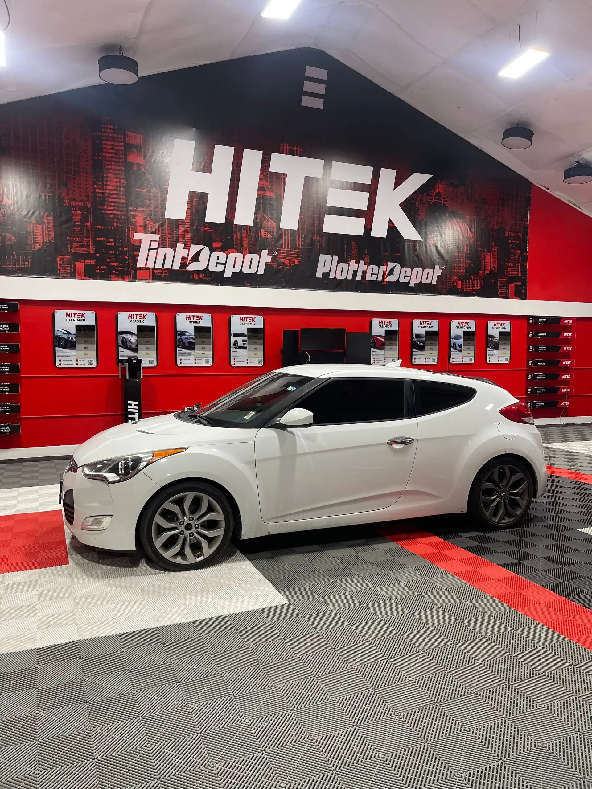 White Hyundai Veloster in a shop with 