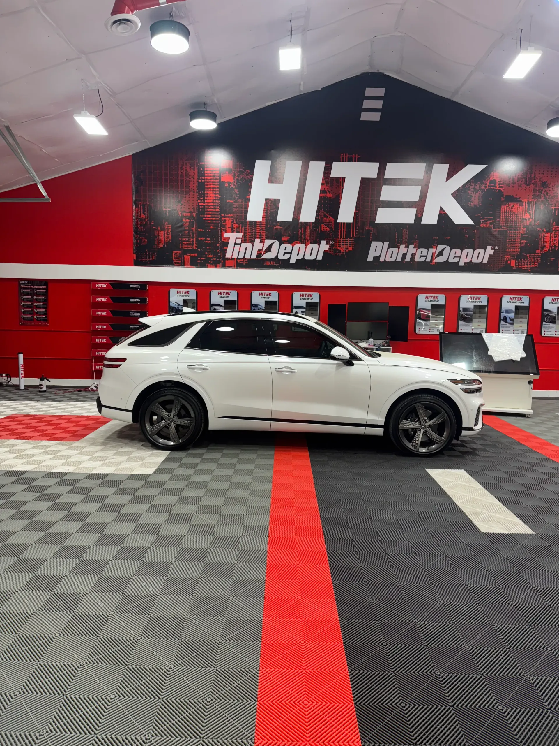 White SUV inside a shop with 