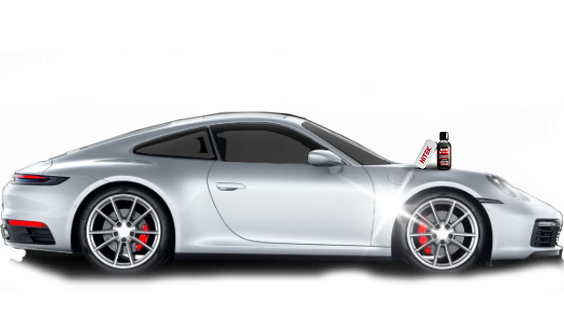 Silver Porsche car with detailing product bottle on the hood; reflective surface.