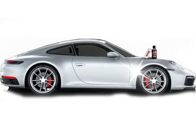 Silver Porsche car with a bottle of car care product on the hood.