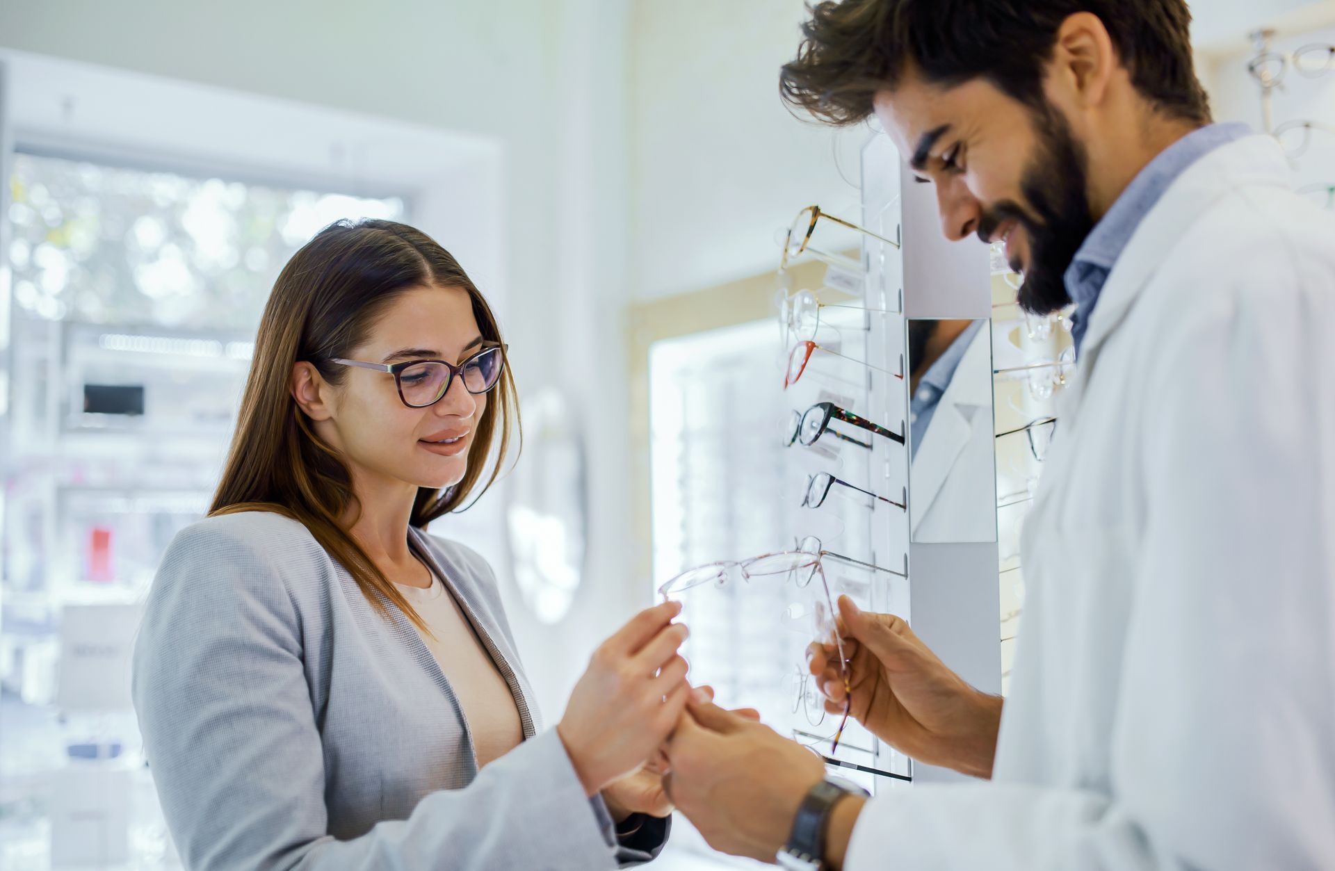 Two lab researchers examining a glass slide in a bright laboratory