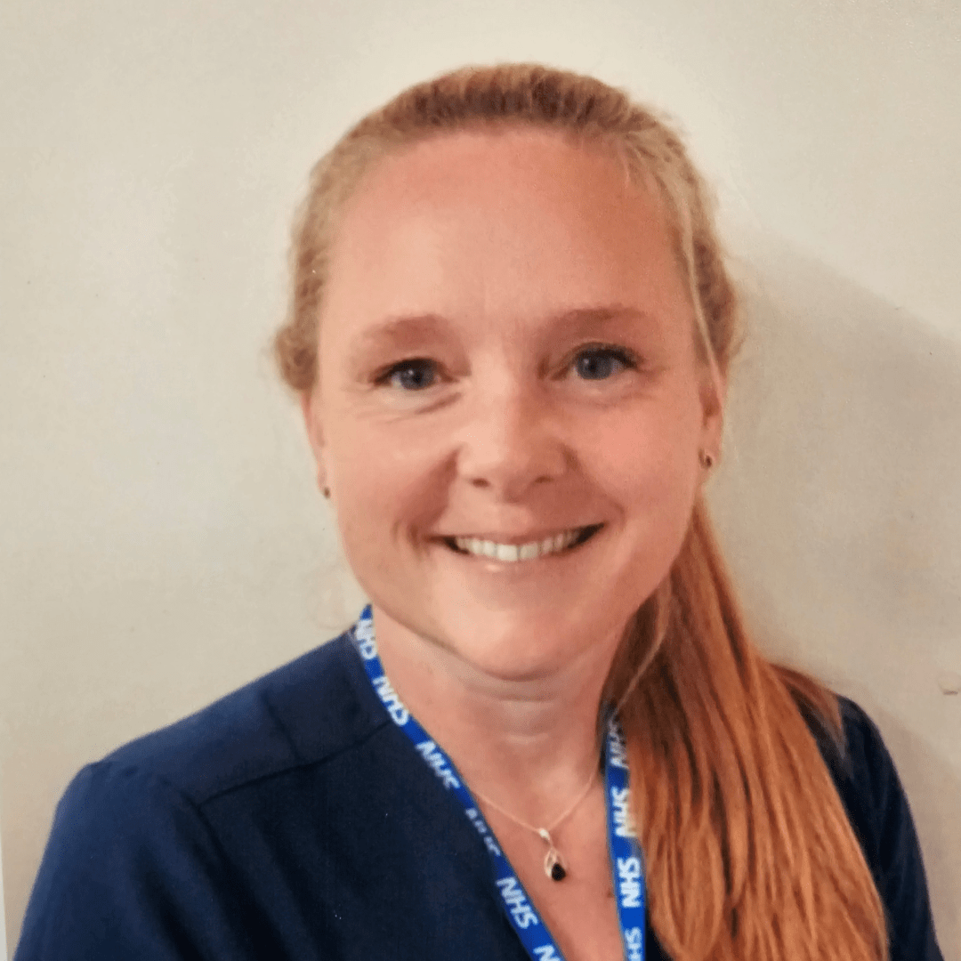 A woman wearing a lanyard that says nhs on it