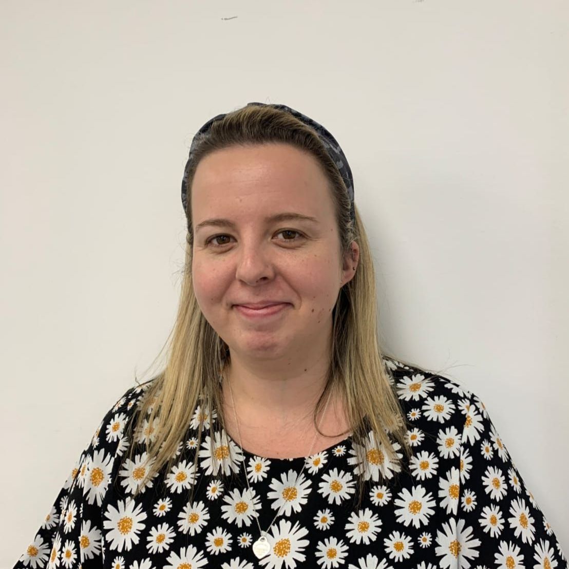 A woman wearing a black shirt with daisies on it