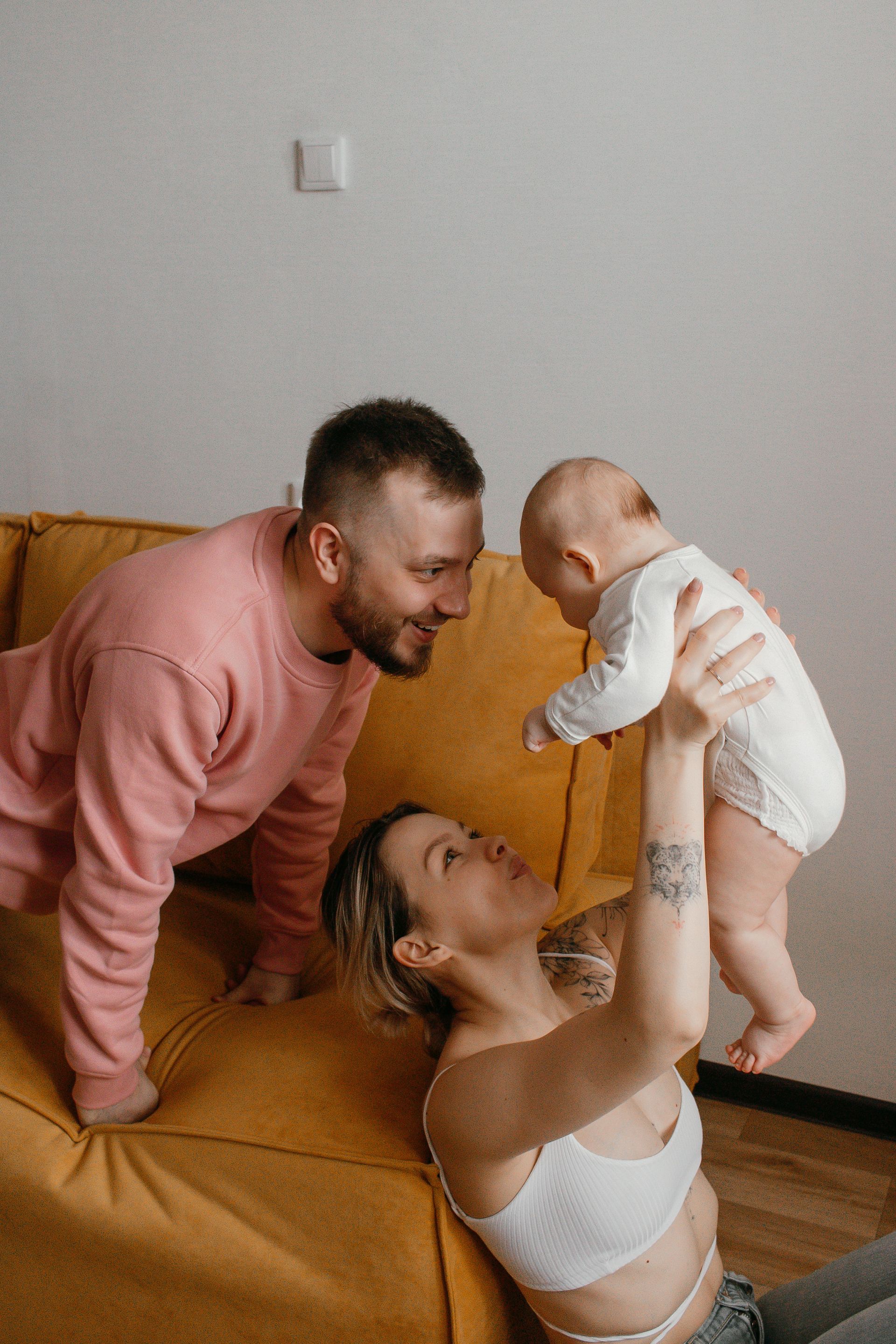 Wooden toy blocks, a plush toy, and a soft blanket arranged on linen, evoking playful family connection