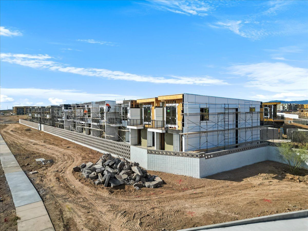 An aerial view of a building under construction in a residential area.