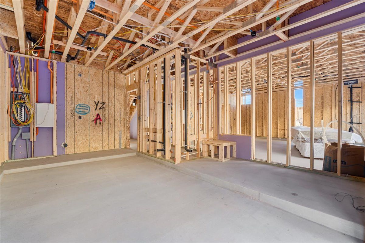 A room in a house under construction with wooden beams.
