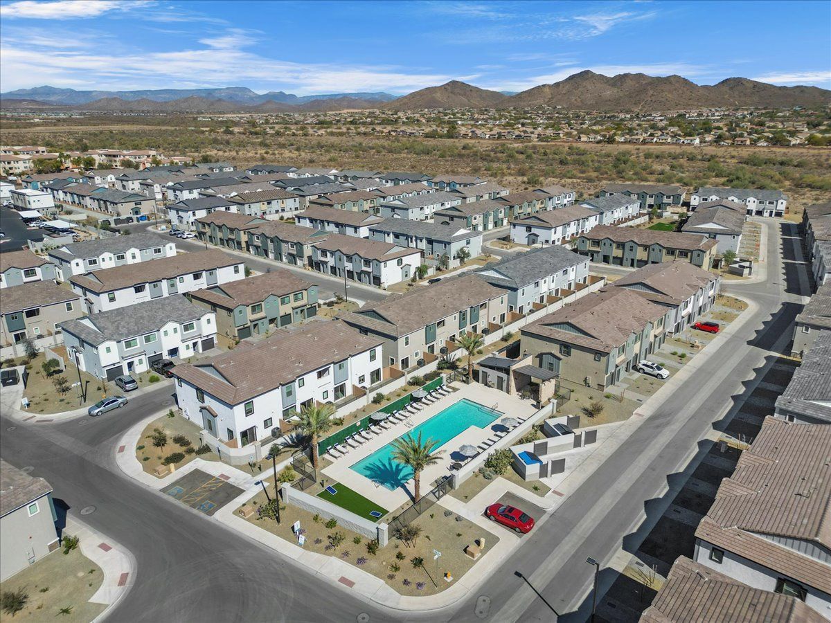 An aerial view of a residential area with a pool in the middle