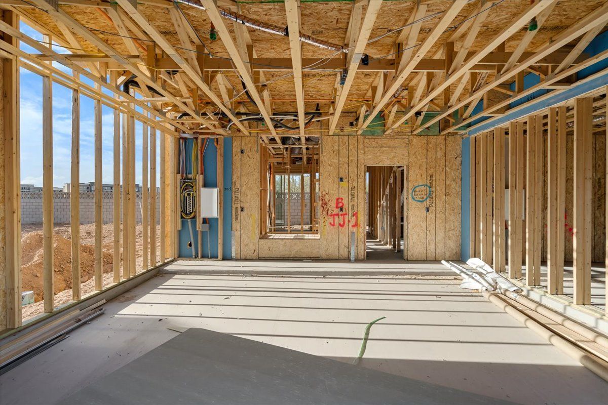 An empty room in a house under construction with wooden beams.