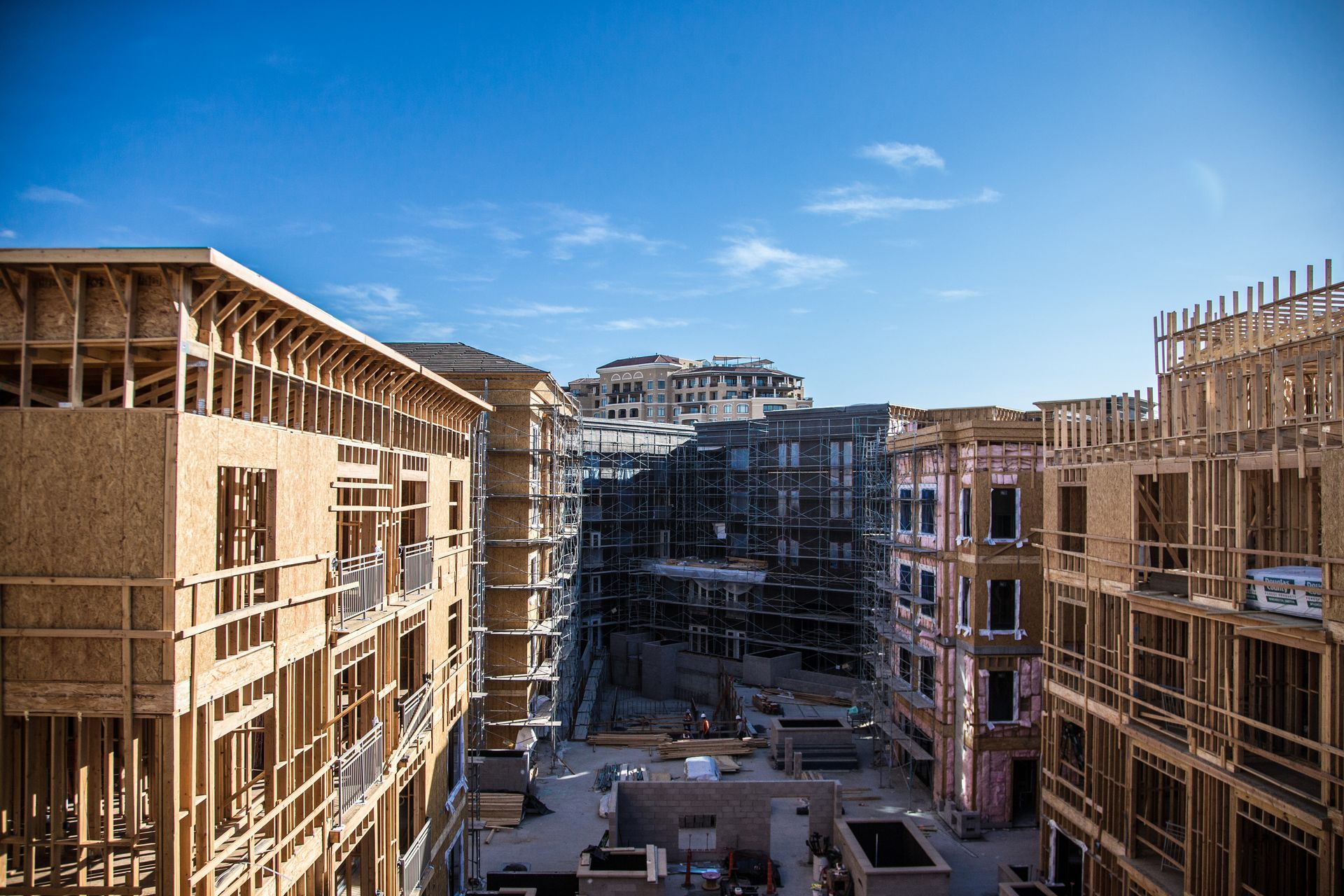 A large building under construction with a blue sky in the background.