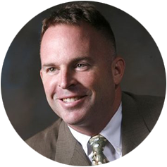 A man in a suit and tie is smiling in a circle A man in a suit and tie is smiling in a circle