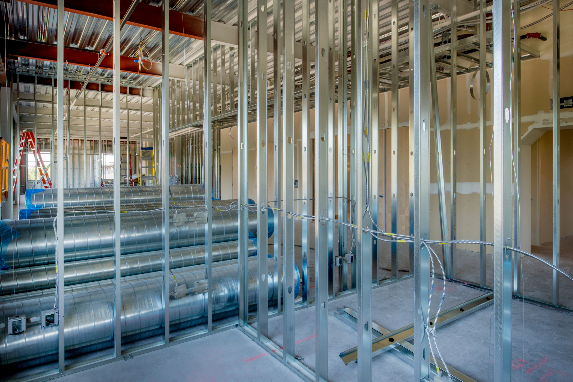Bright rehabilitation room with treatment tables, equipment, and large windows