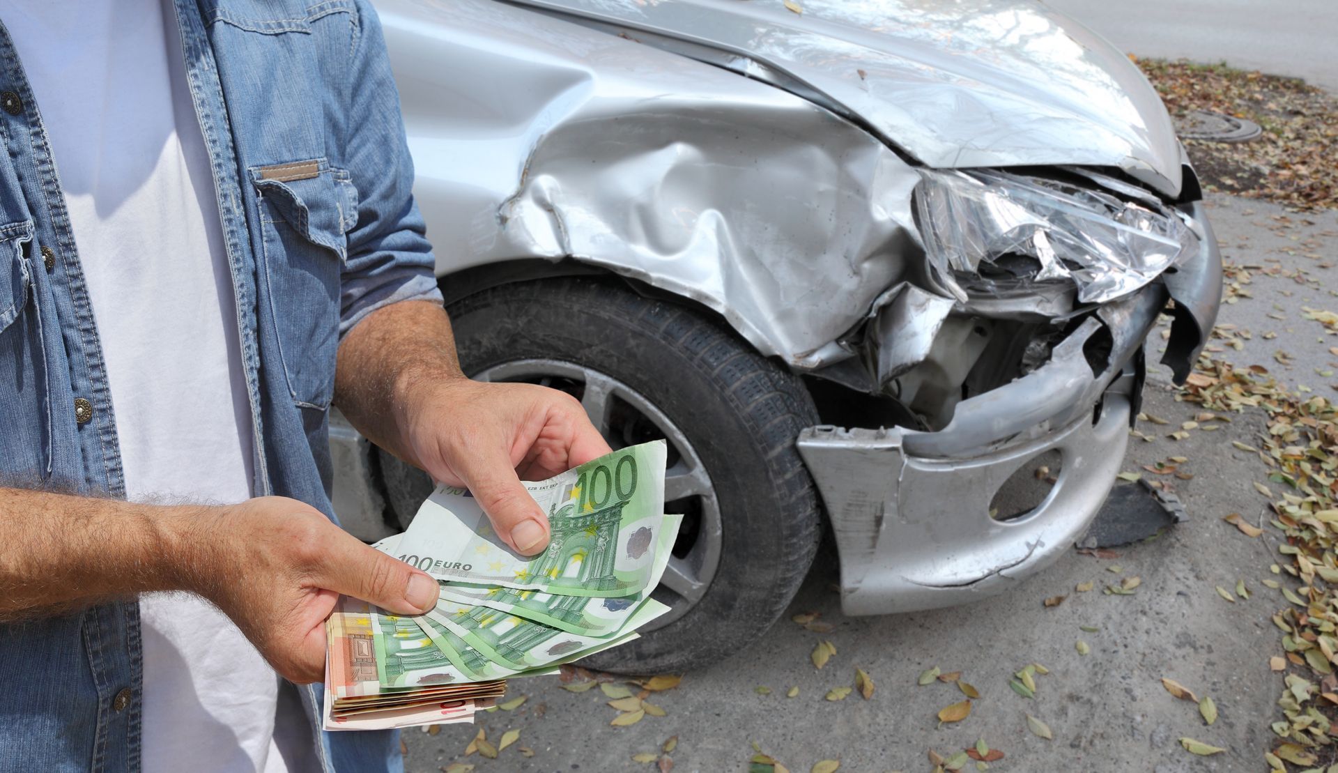 Damaged car inspection and male hands holding money.
