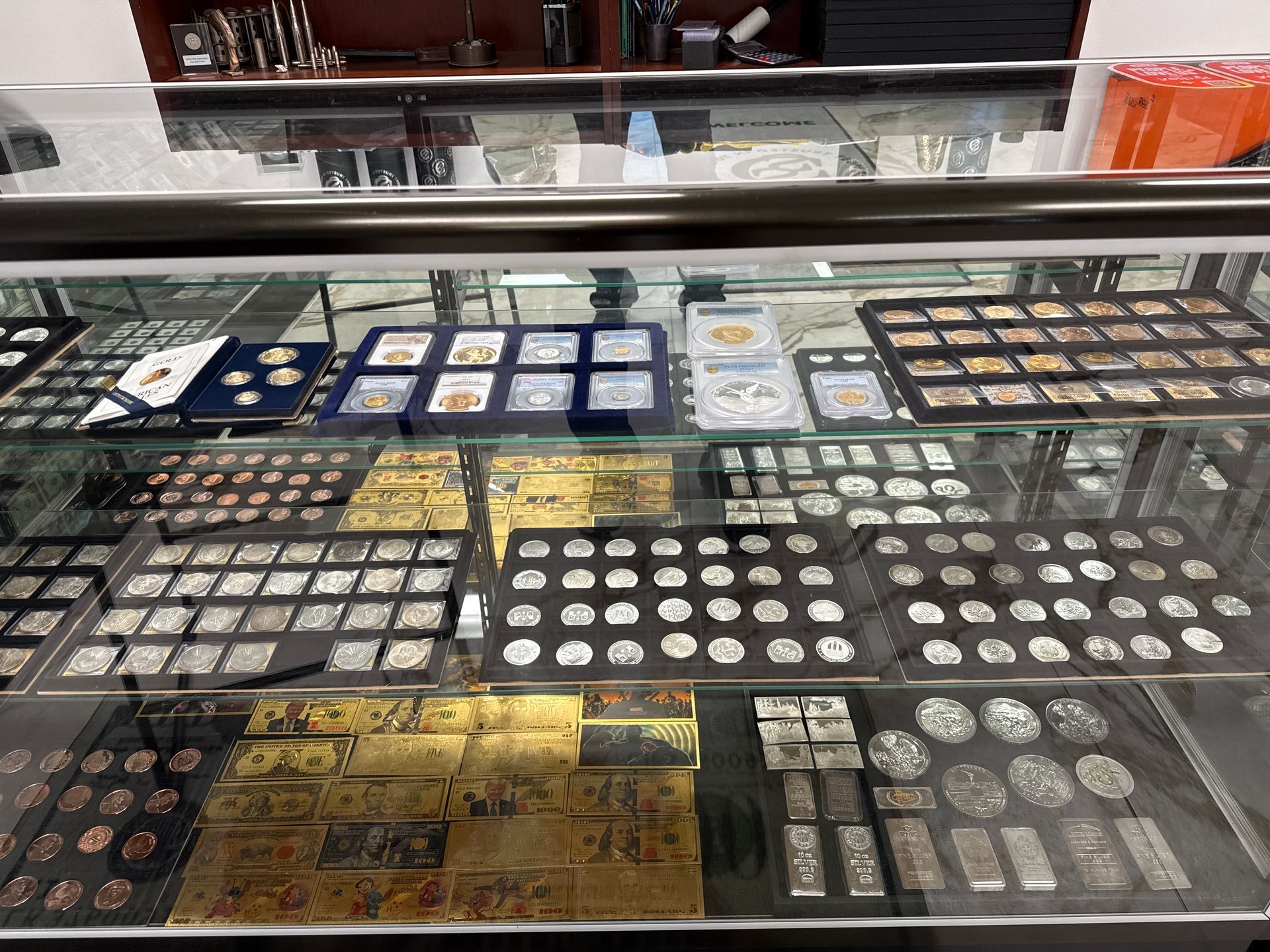 Silver bullion bars and graded coins at Scottsdale Coin Shop, a trusted dealer for Gilbert-area sellers