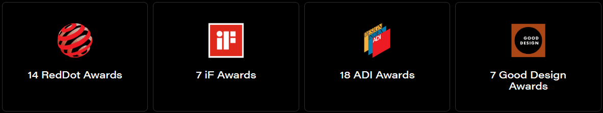 Four design award logos: Red Dot, iF, G-Mark, and Good Design, displayed in white text on a black background.