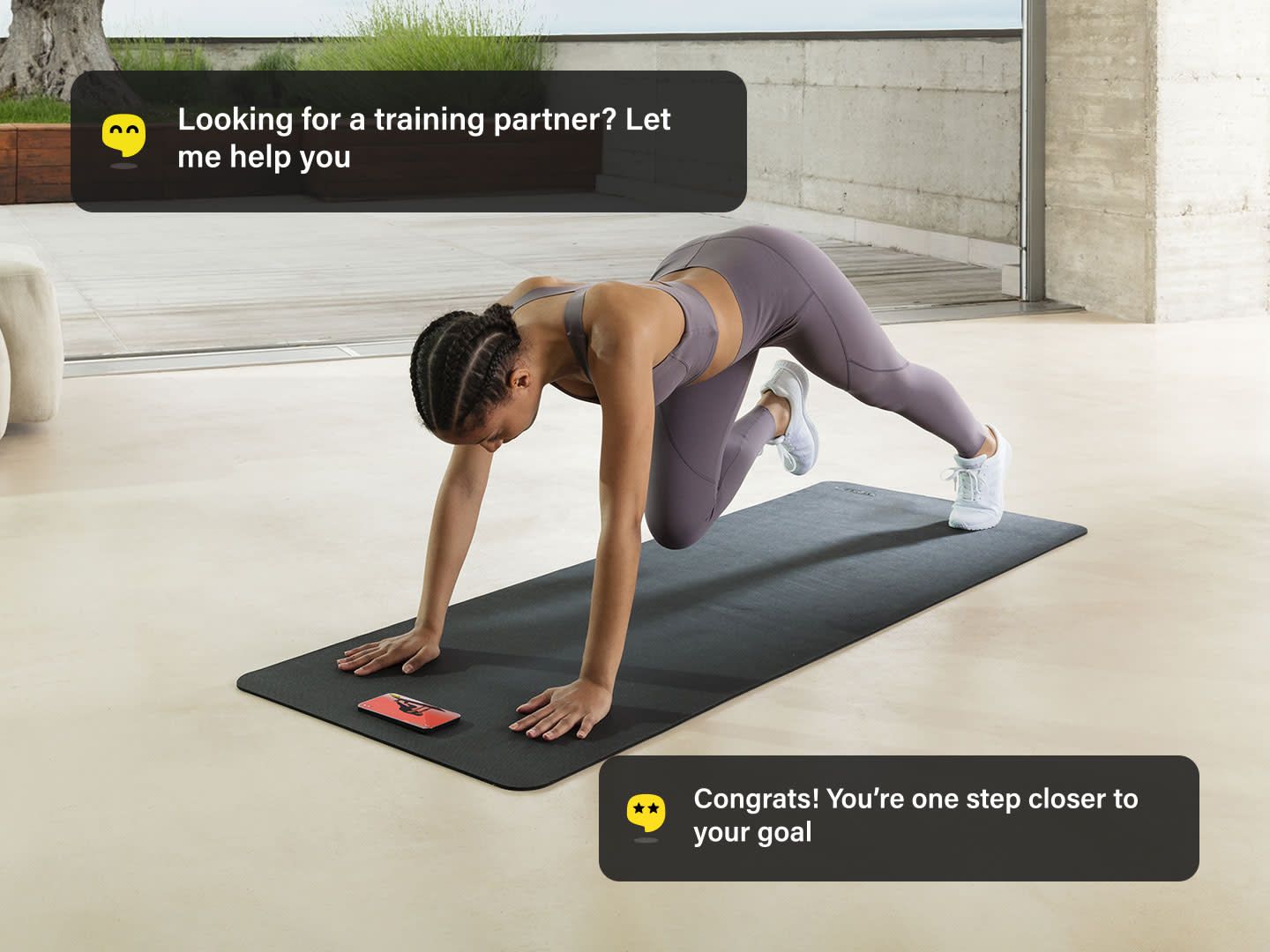 A person in purple workout clothes performs a mountain climber exercise on a mat with two digital notification pop-ups.