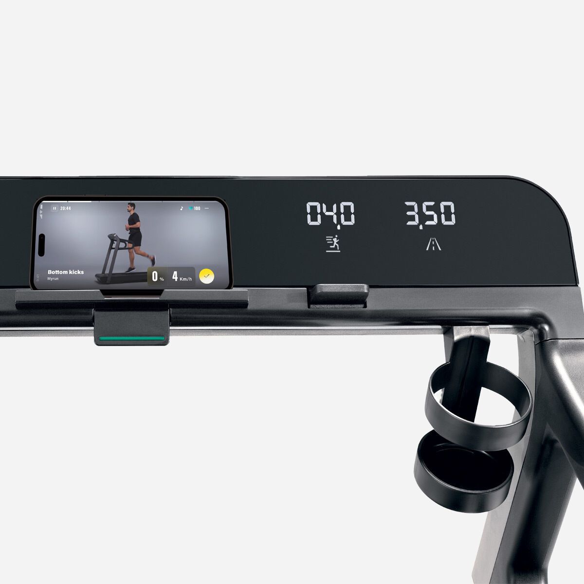 The console of a black treadmill features a smartphone holder with a video playing, a digital display, and a cup holder.