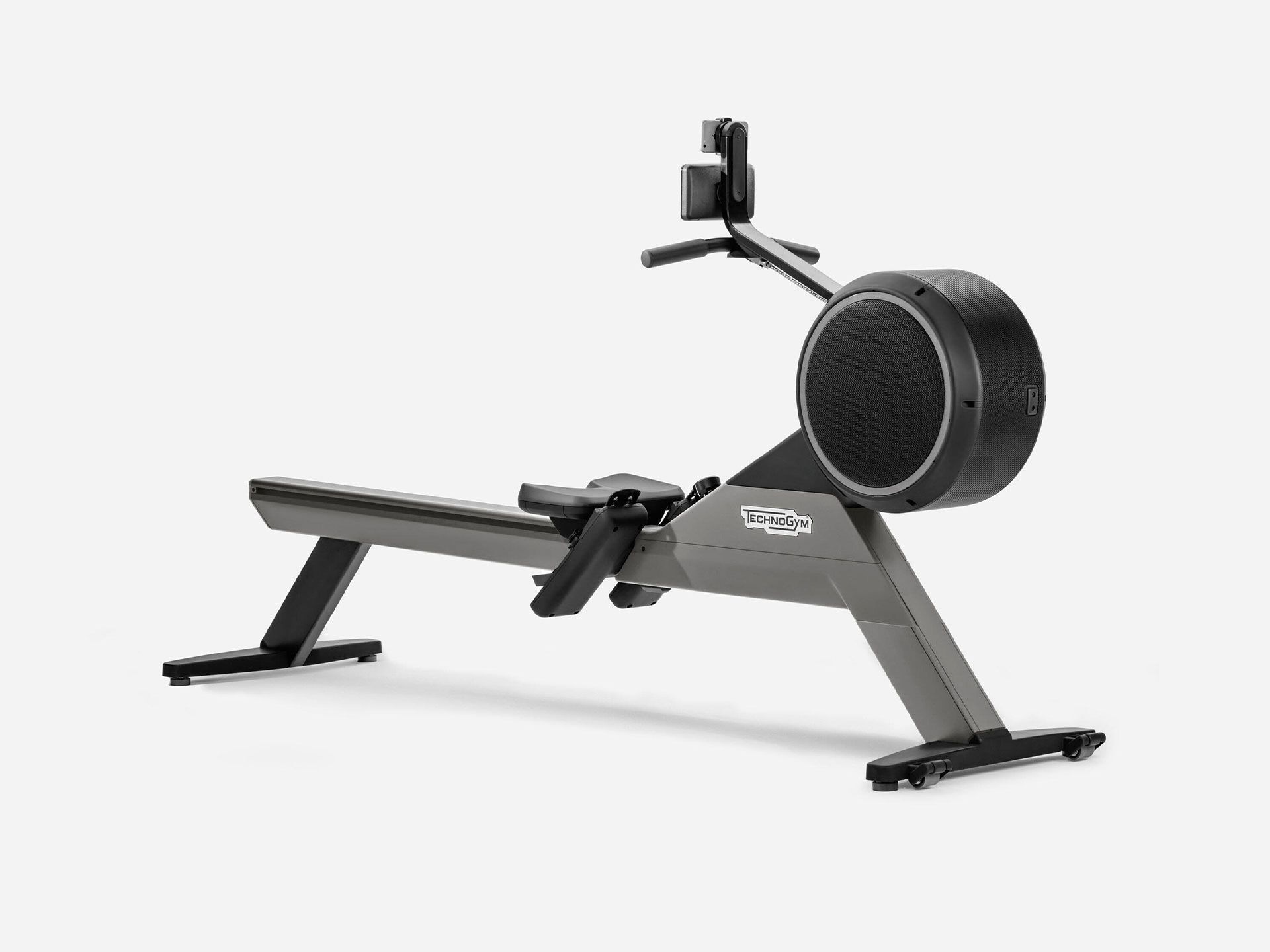 A charcoal grey Technogym Skillrow rowing machine on a plain white background.
