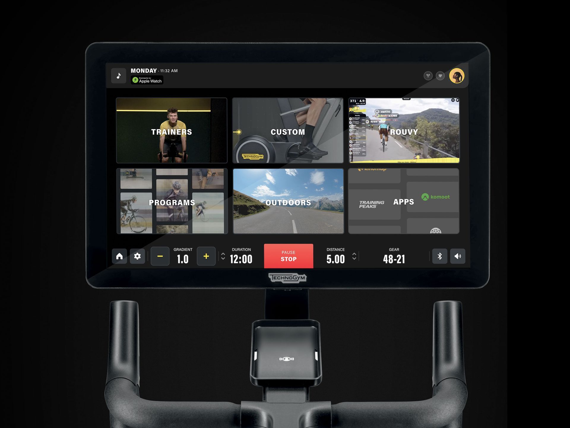 A Technogym stationary bike console screen displaying various workout class options and performance metrics.