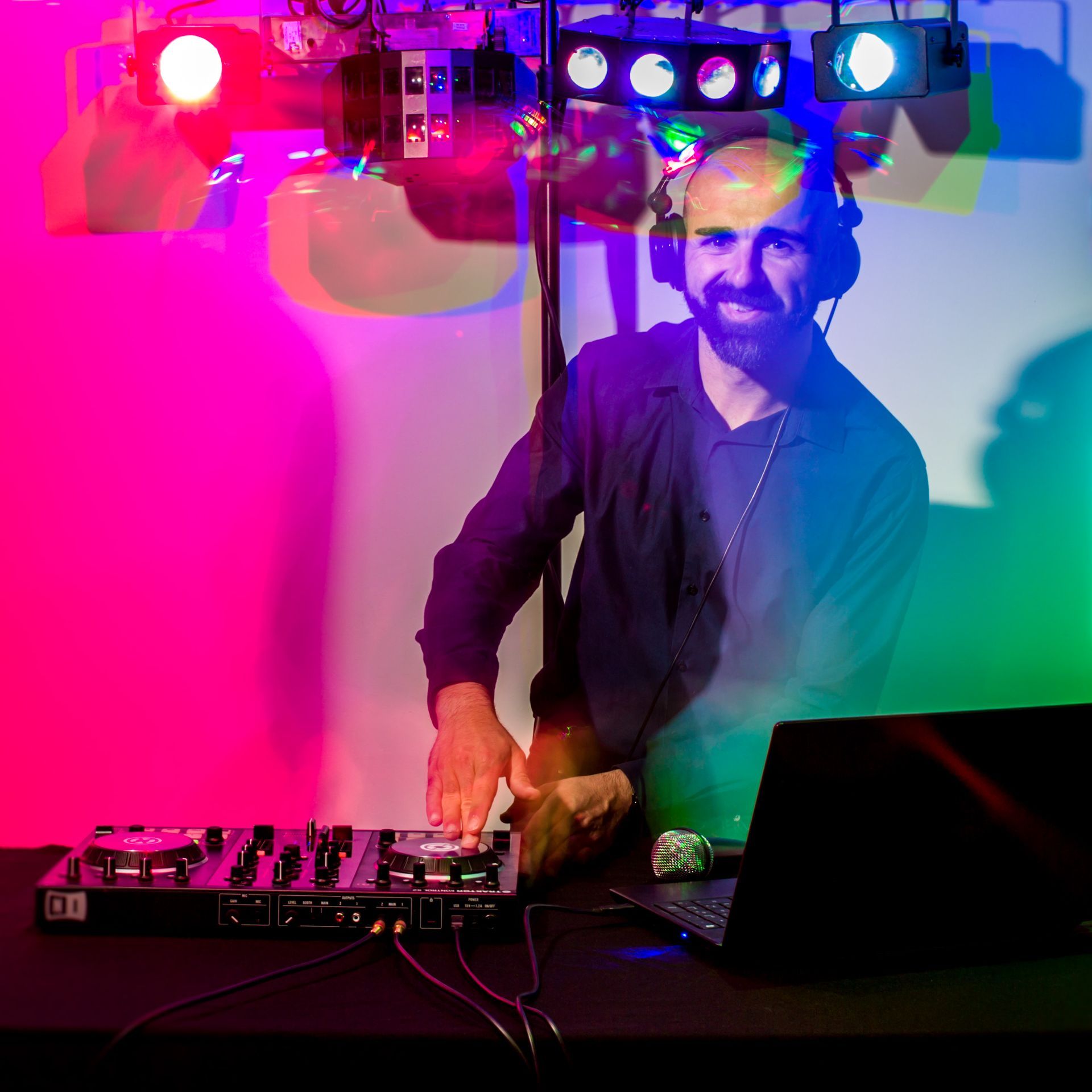 A man wearing headphones is playing a dj set