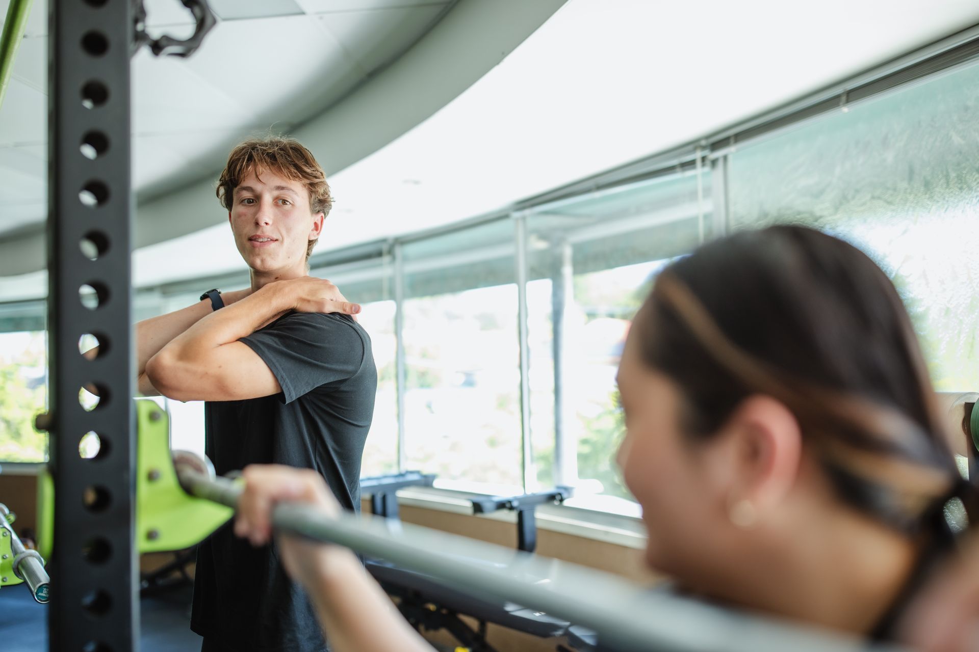 A group of women are doing lunges in a gym.