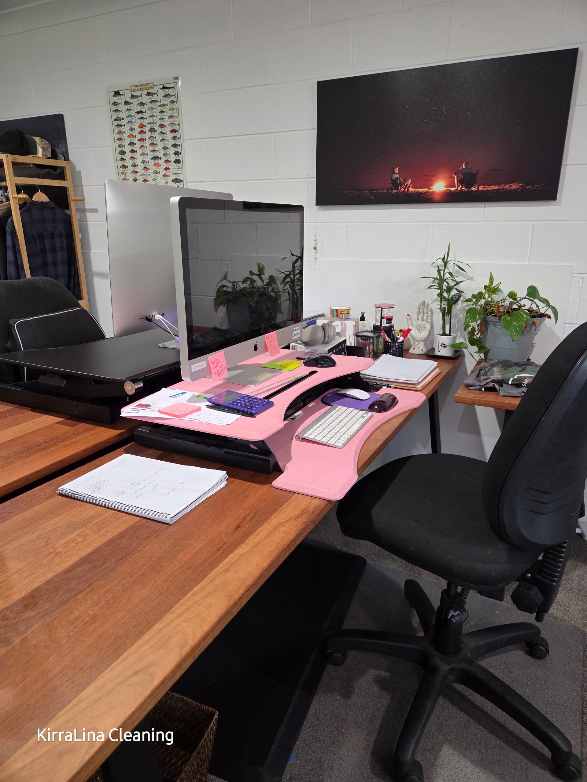 A Computer on a Wooden Desk with Pink Stand — KirraLina Cleaning Services in Palm Beach, NSW