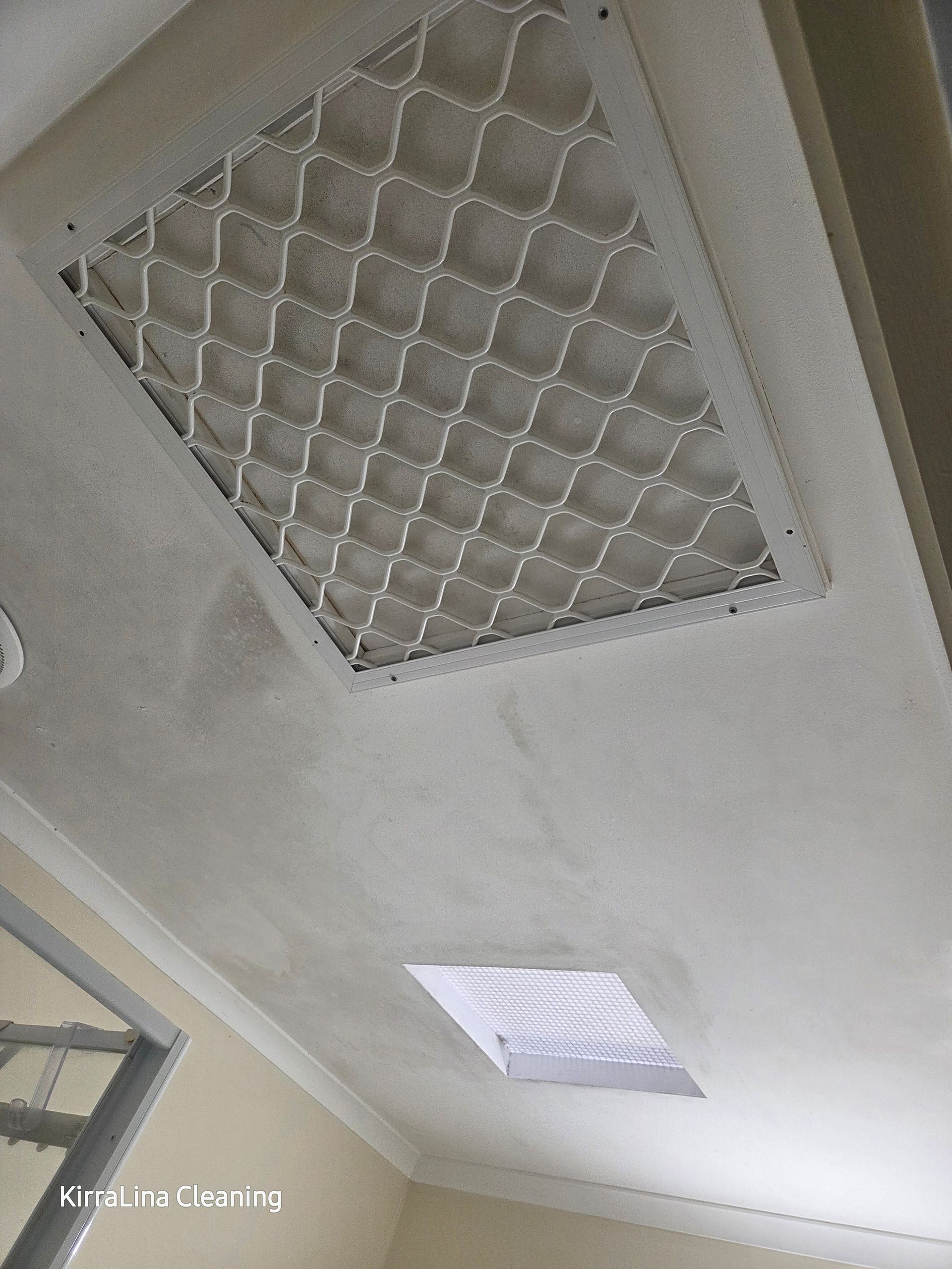 A Ceiling Featuring a Square Air Return Vent with A Metal Grate and A Rectangular Recessed Light Fixture — KirraLina Cleaning Services in Tweed Heads, NSW