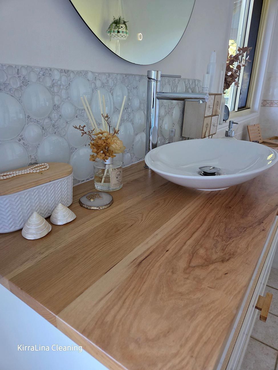 A Modern Bathroom Counter with A Wooden Surface — KirraLina Cleaning Services in Tweed Heads, NSW