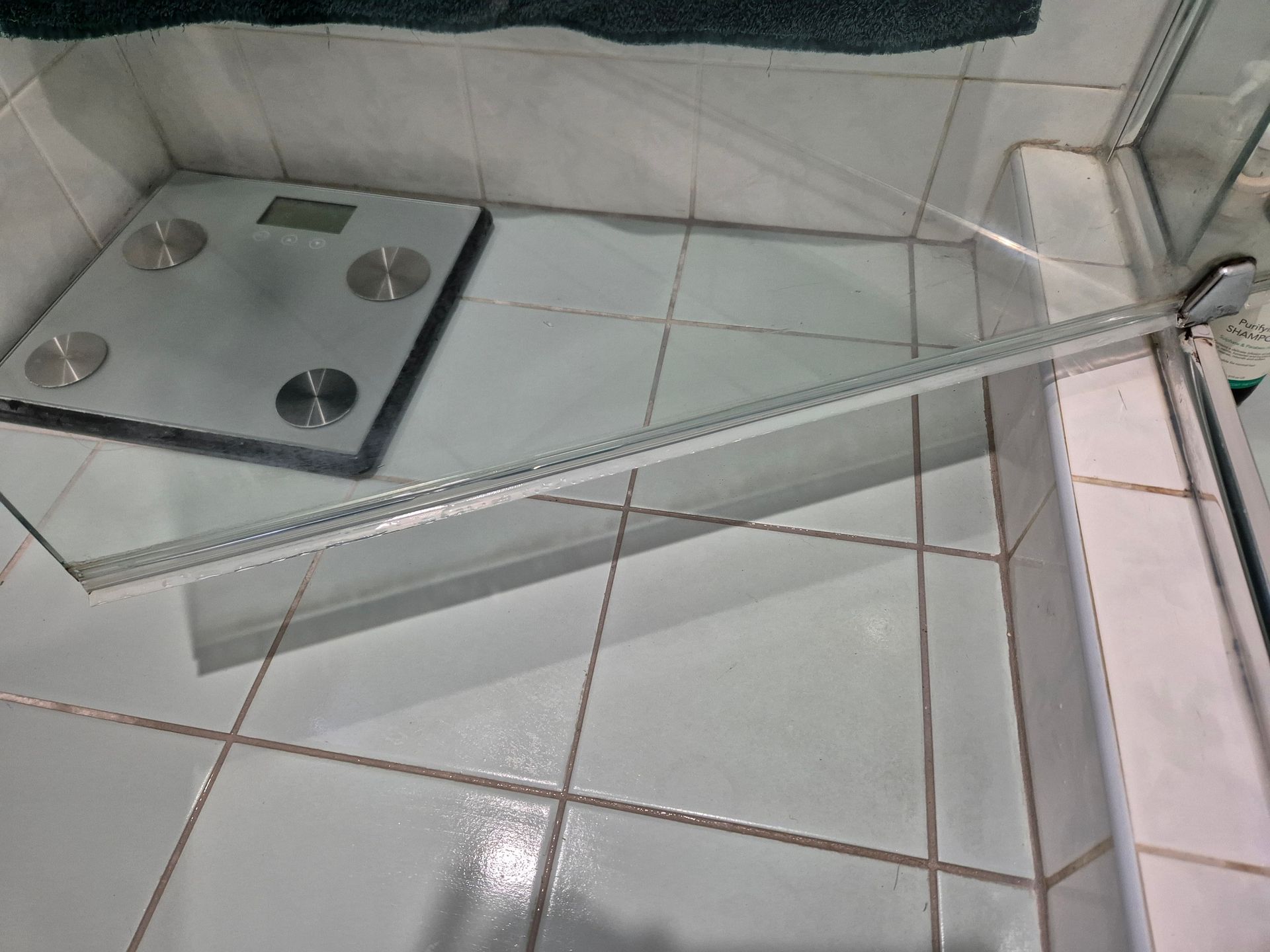 After: A Glass Shower Door, a Body Scale, and White Tiled Floor in a Bathroom — KirraLina Cleaning Services in Palm Beach, NSW