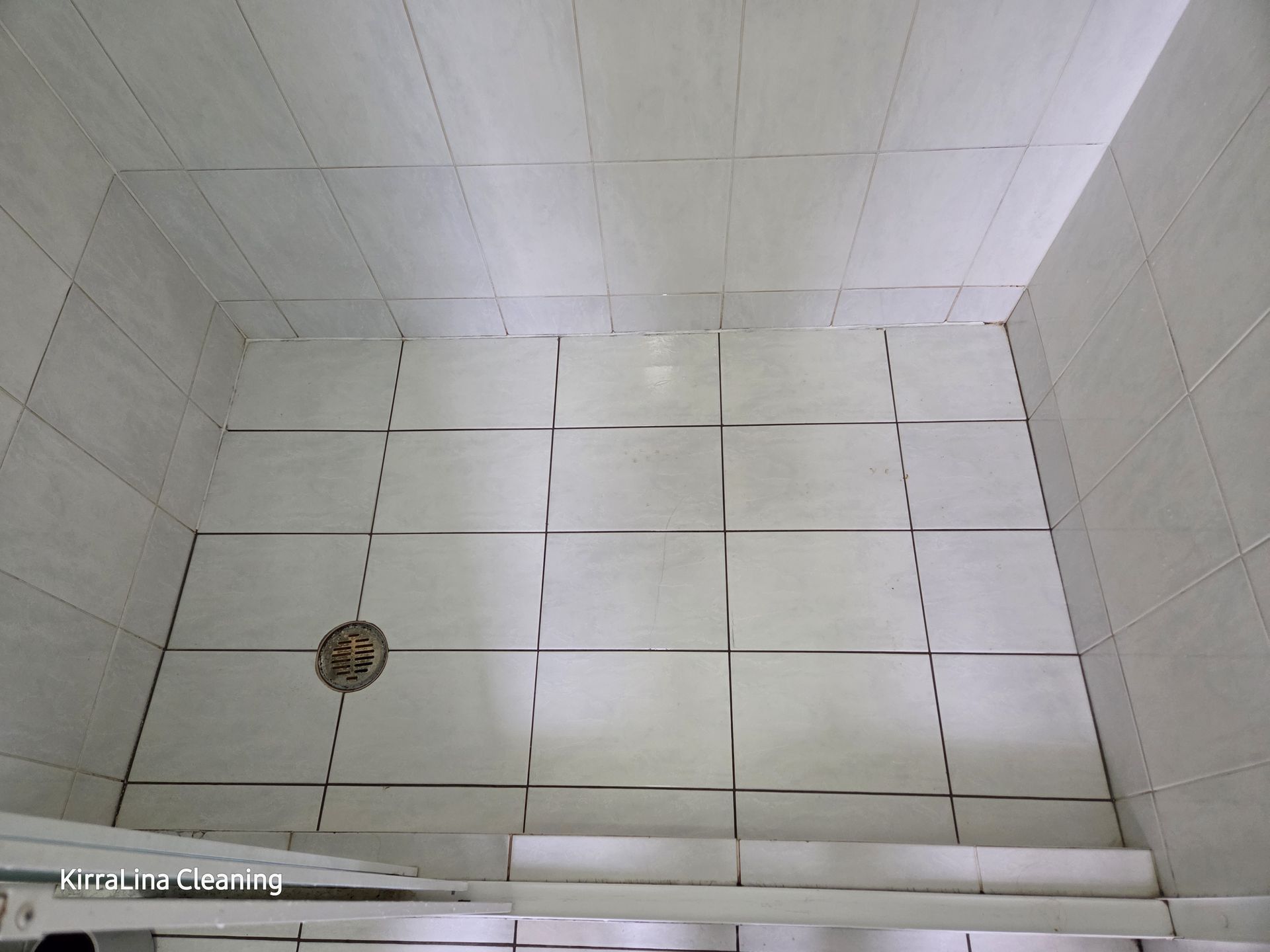 White Tiled Shower Stall With a Drain and Step-up Threshold, Viewed From Above — KirraLina Cleaning Services in Tweed Heads, NSW