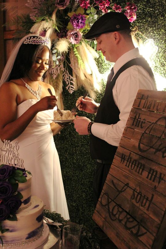 couple at wedding eating wedding cake together