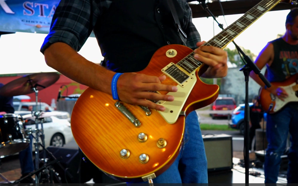 guitar player on stage playing show