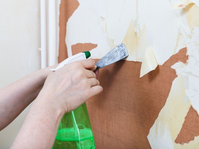 A person in a white apron is working in a kitchen