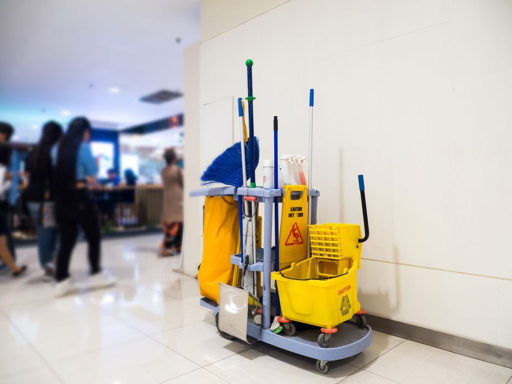 Cleaning Cart With Supplies Near a Wall in a Public Area — Cairns Local Cleaning Services in Woree, QLD
