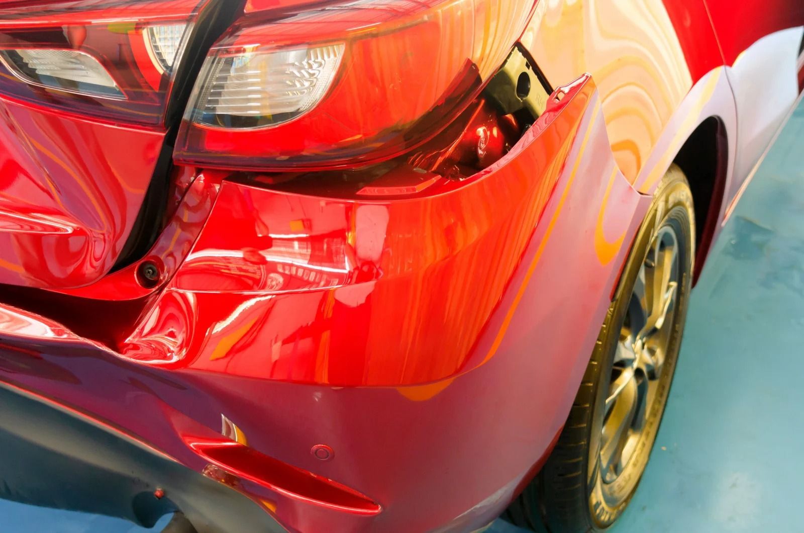 Red car with damaged rear end