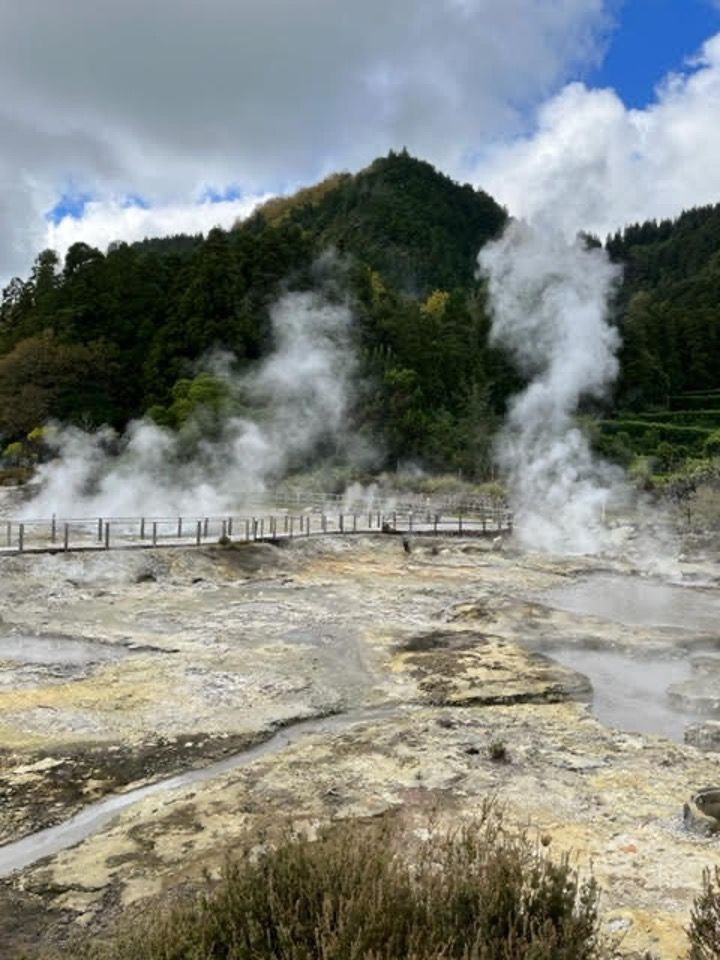 there is a lot of steam coming out of the ground .