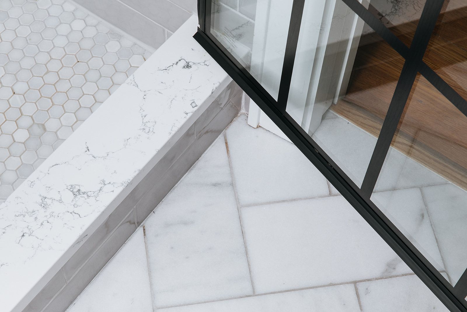 A white tile floor next to a glass door
