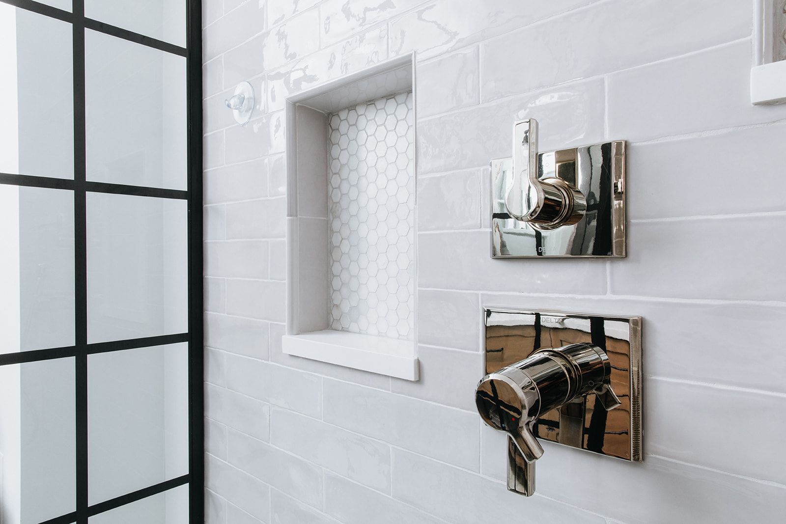 A close up of a shower faucet in a bathroom
