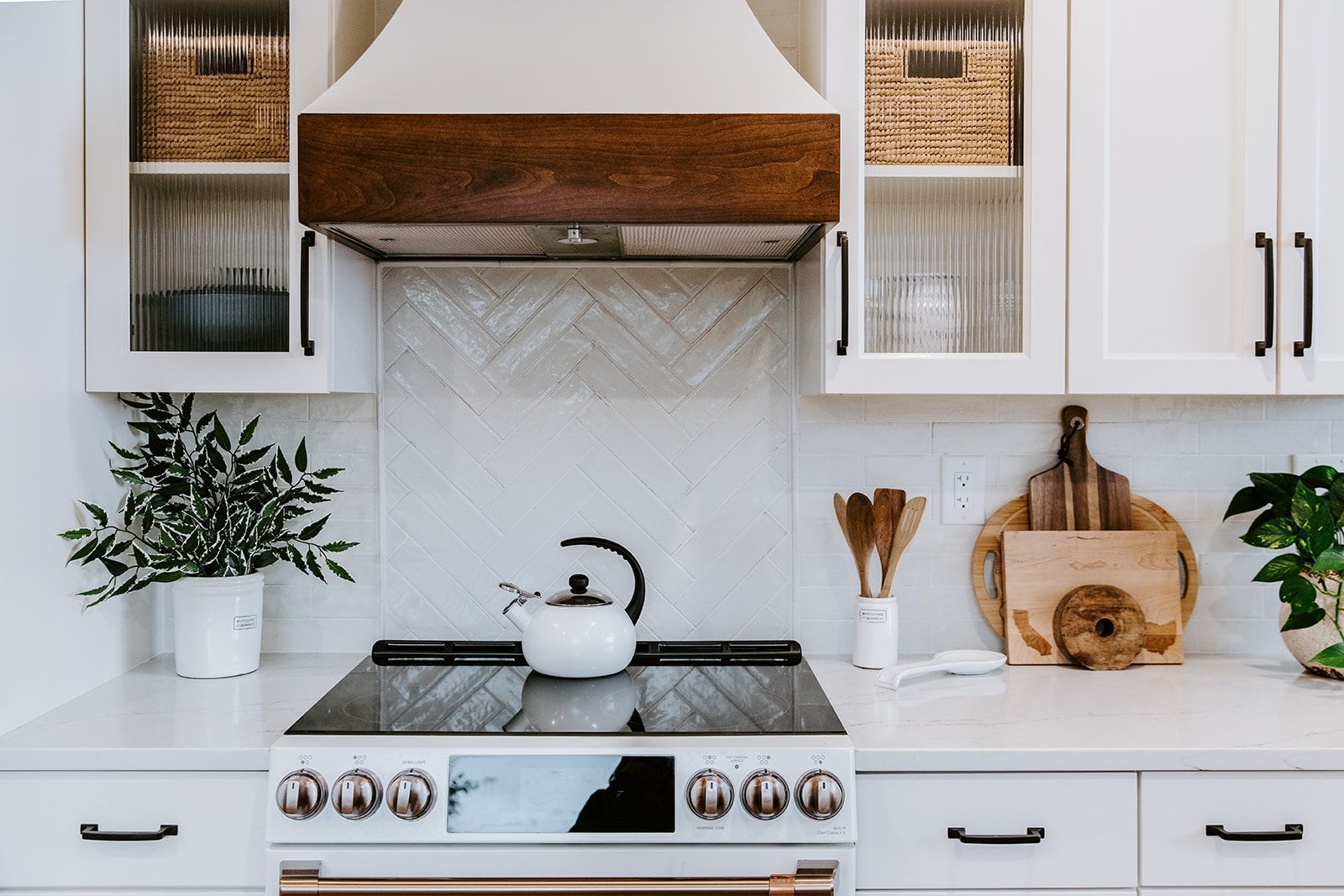 A kitchen with a stove and a kettle on it