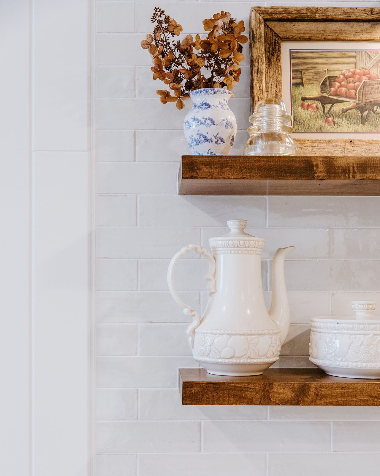 A wooden shelf with a vase of flowers 