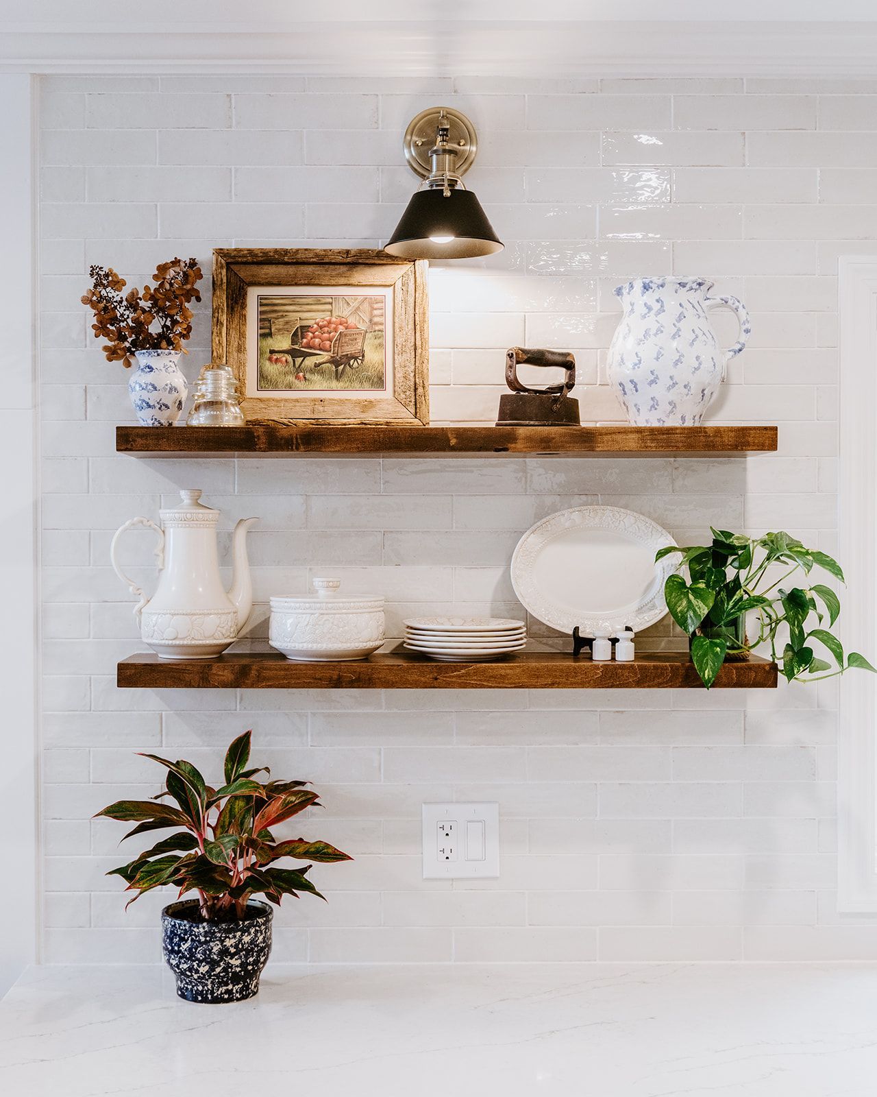 A kitchen with three wooden shelves